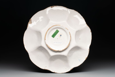 A blue, white and yellow Dutch Delftware dish with a putto, Delft or Haarlem, 17th C.