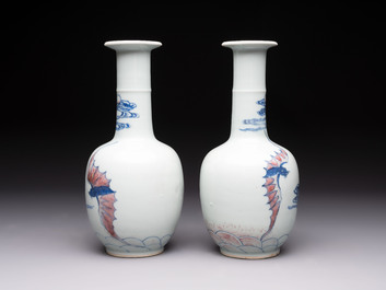 A pair of Chinese blue, white and copper-red 'bats among the clouds' vases, 19th C.