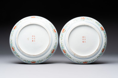 A pair of Chinese polychrome-decorated blue and white plates and a blue and white covered jar, Qianlong mark, 19th C.