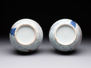 A pair of Chinese blue, white and copper-red 'bats among the clouds' vases, 19th C.