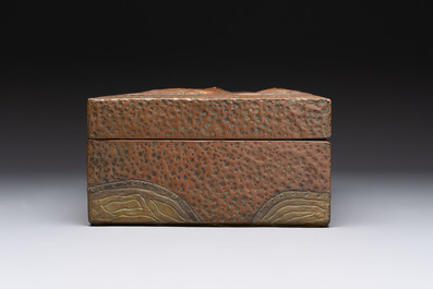 Alfred Daguet (Paris, 1875-1942): An Art Nouveau repouss&eacute; brass- and copper-mounted box with 'crabs' design and inset glass eyes, ca. 1900