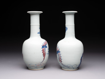 A pair of Chinese blue, white and copper-red 'bats among the clouds' vases, 19th C.