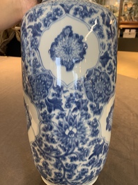 A Chinese blue and white 'flower scrolls' rouleau vase, Kangxi