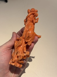 A Chinese red coral figure of a goddess on wooden stand, 19/20th C.