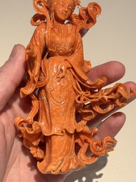 A Chinese red coral figure of a goddess on wooden stand, 19/20th C.