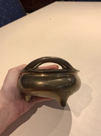 A Chinese bronze tripod censer with two handles, Xuande mark, 19th C.