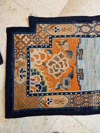 Two Tibetan saddle rugs with floral design, 19th C.