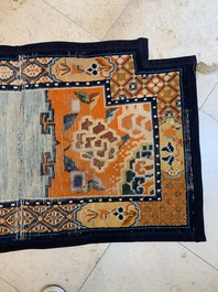 Two Tibetan saddle rugs with floral design, 19th C.
