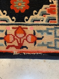 Two Tibetan saddle rugs and three small rugs, 19th C.