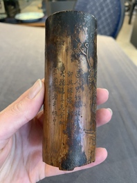 Two Chinese carved bamboo brush pots and an ink stone with wooden cover and stand, signed He Xuanting 何選廷 and Dian Liangbi 典良弼, 19th C.