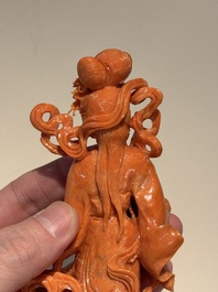 A Chinese red coral figure of a goddess on wooden stand, 19/20th C.