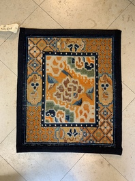 Two Tibetan saddle rugs and three small rugs, 19th C.