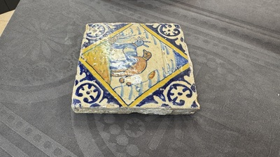 A polychrome Dutch Delft maiolica 'mating dogs' diamond tile, late 16th C.