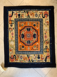 Two Tibetan saddle rugs and three small rugs, 19th C.