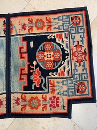 Two Tibetan saddle rugs and three small rugs, 19th C.