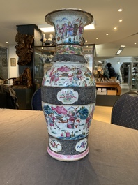 A pair of Chinese Nanking famille rose vases with narrative design, 19th C.
