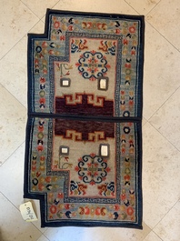 Two Tibetan saddle rugs and three small rugs, 19th C.