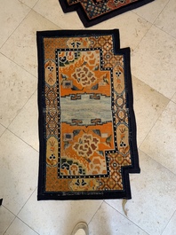 Two Tibetan saddle rugs with floral design, 19th C.