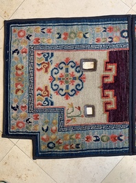 Two Tibetan saddle rugs and three small rugs, 19th C.