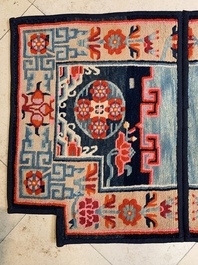 Two Tibetan saddle rugs and three small rugs, 19th C.