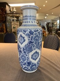 A Chinese blue and white 'flower scrolls' rouleau vase, Kangxi