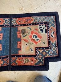 Two Tibetan saddle rugs with floral design, 19th C.