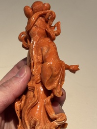 A Chinese red coral figure of a goddess on wooden stand, 19/20th C.