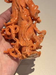 A Chinese red coral figure of a goddess on wooden stand, 19/20th C.