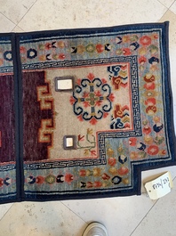 Two Tibetan saddle rugs and three small rugs, 19th C.