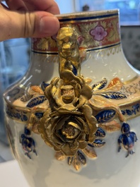 A pair of Chinese export famille rose urns and covers, Qianlong
