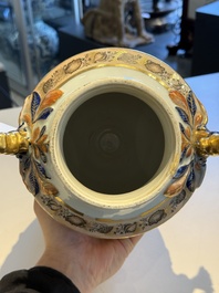 A pair of Chinese export famille rose urns and covers, Qianlong