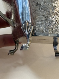 A Chinese silver covered teapot, sugar jar and milk jug with bamboo design, Tackhing 90% silver mark, 20th C.