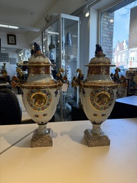 A pair of Chinese export famille rose urns and covers, Qianlong