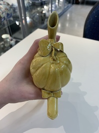 A Chinese celadon-glazed water dropper, a yellow-glazed ewer, a famille noire covered vase and a miniature model, 19th C.