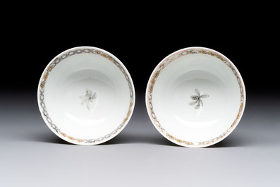 A pair of Chinese grisaille and iron-red 'landscape' cups and saucers, Yongzheng/Qianlong