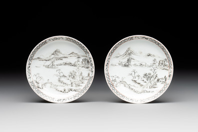 A pair of Chinese grisaille and iron-red 'landscape' cups and saucers, Yongzheng/Qianlong