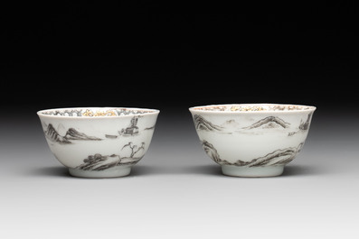 A pair of Chinese grisaille and iron-red 'landscape' cups and saucers, Yongzheng/Qianlong