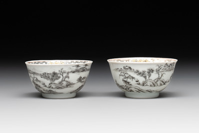 A pair of Chinese grisaille and iron-red 'landscape' cups and saucers, Yongzheng/Qianlong