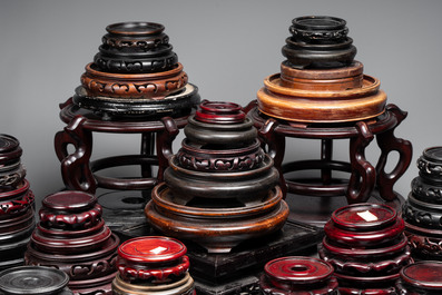 A collection of 100 Chinese wooden stands, 19/20th C.