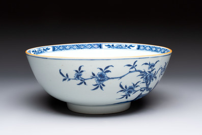 A Chinese blue and white punch bowl with a lady and two boys in a garden, Qianlong