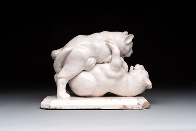 A rare white-glazed Delftware group of two fighting felines, early 18th C.