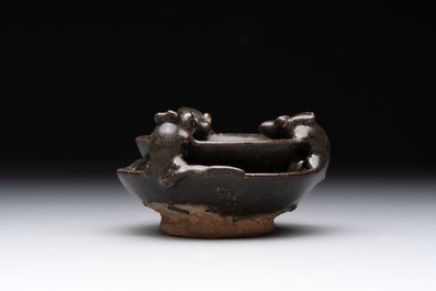 A rare Chinese black-glazed two-tier oil lamp with three rats, Ming