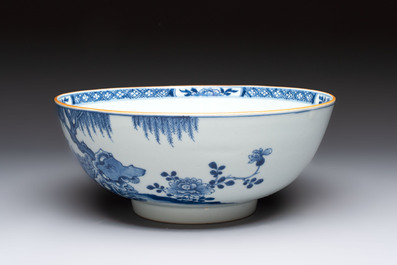 A Chinese blue and white punch bowl with a lady and two boys in a garden, Qianlong