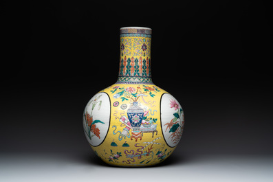 A large Chinese famille rose yellow-ground 'tianqiu ping' vase with flowers and antiquities, 19th C.