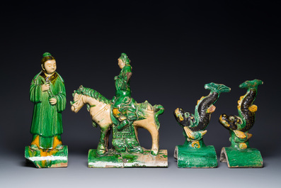 A pair of Chinese sancai-glazed roof tiles in the shape of fish, a warrior on horseback and a sage, Ming