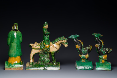 A pair of Chinese sancai-glazed roof tiles in the shape of fish, a warrior on horseback and a sage, Ming