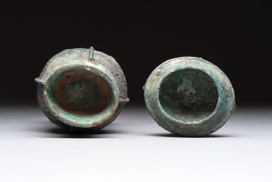A Chinese archaic bronze food vessel and cover with taotie design, 'zhi 觶', Shang