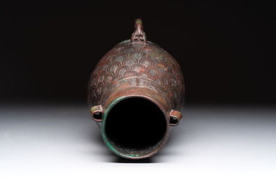 A Chinese archaic bronze inscribed wine vessel with scale design, 'hu 壺', Zhou