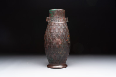 A Chinese archaic bronze inscribed wine vessel with scale design, 'hu 壺', Zhou