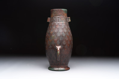 A Chinese archaic bronze inscribed wine vessel with scale design, 'hu 壺', Zhou